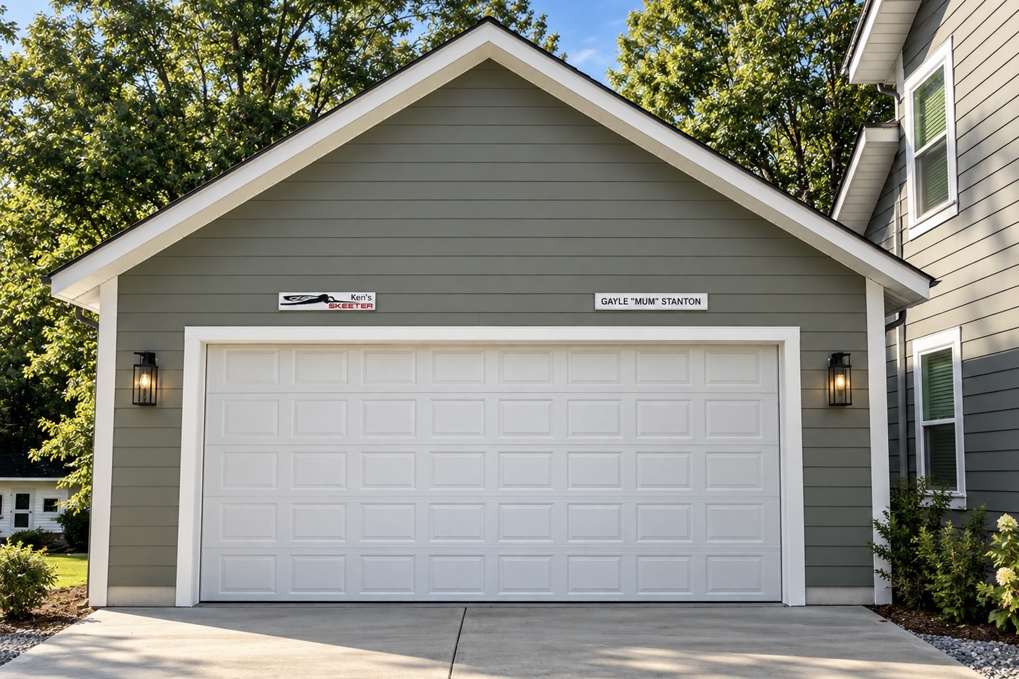 Completed single-bay detached garage with gray siding and white trim