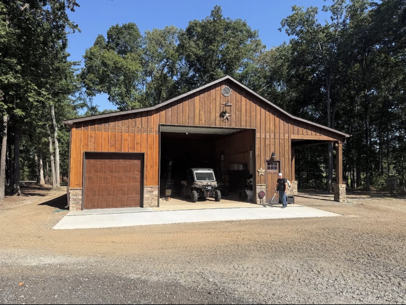 Rustic wood-clad workshop garage with covered patio