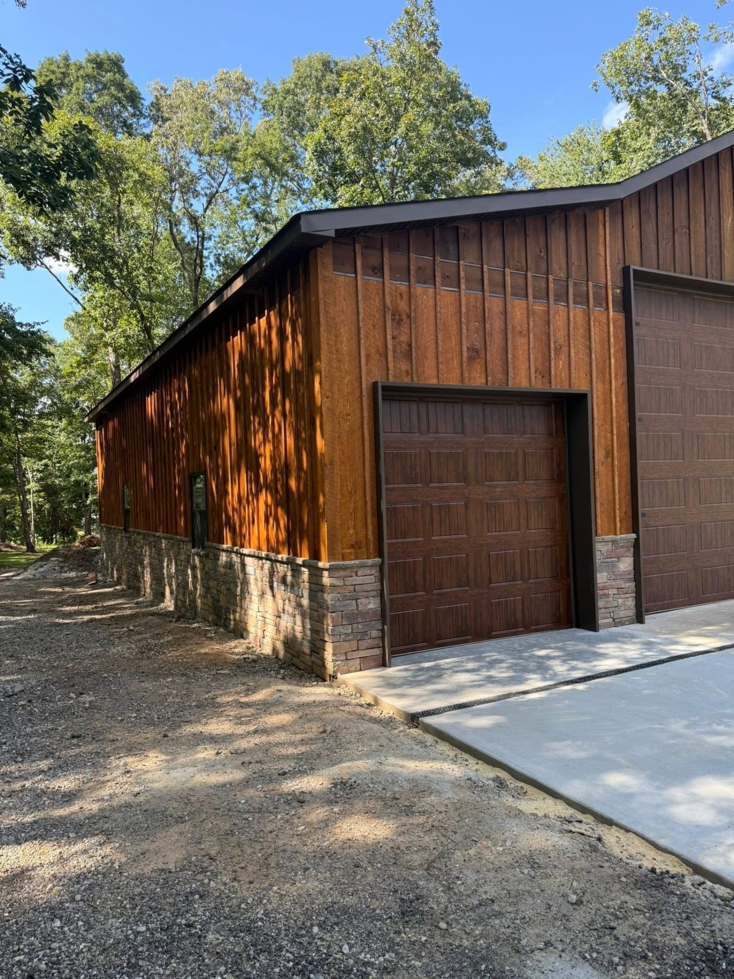 Cedar board and batten workshop with stone wainscoting