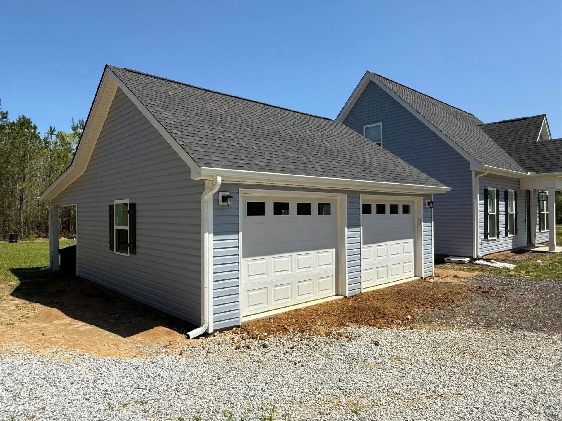 Gray vinyl siding detached garage matching main home
